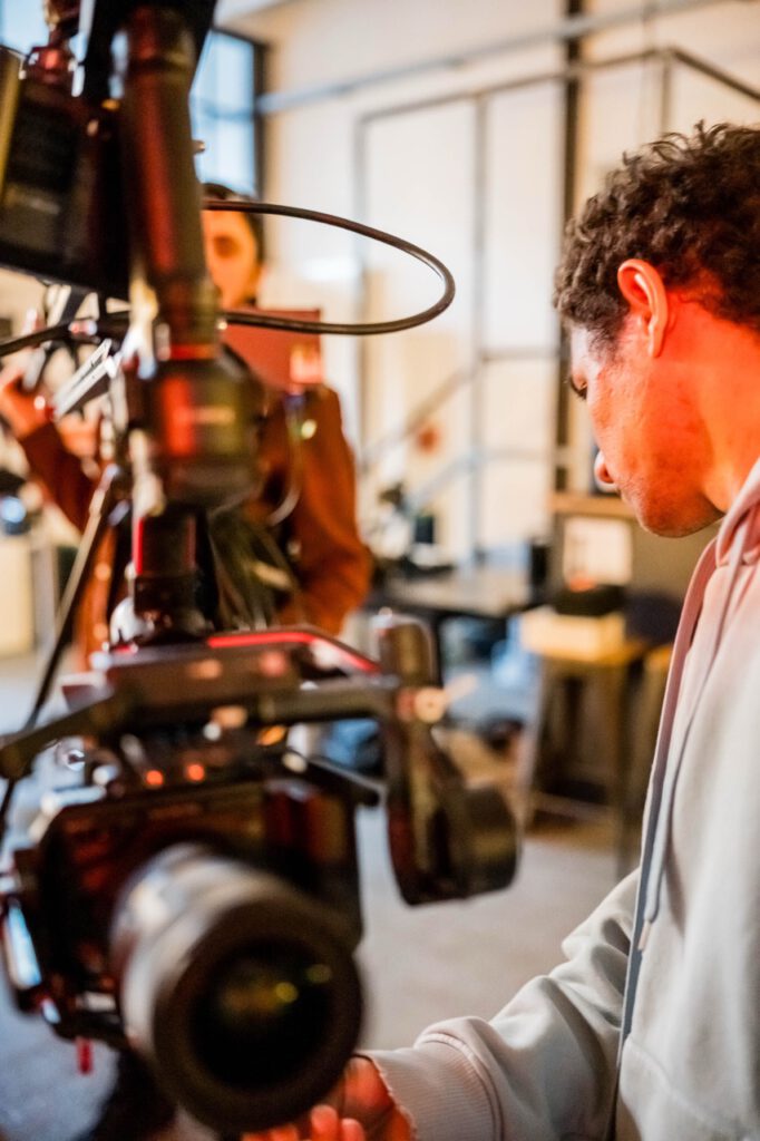 Close-up of a videographer operating a cinema camera rig